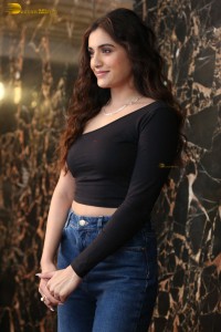 actress divyansha kaushik in a black top and denim jeans