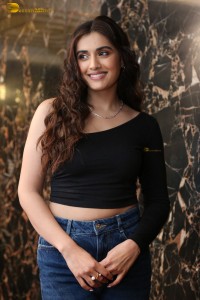 actress divyansha kaushik in a black top and denim jeans