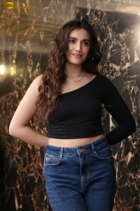 actress divyansha kaushik in a black top and denim jeans