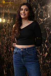 actress divyansha kaushik in a black top and denim jeans
