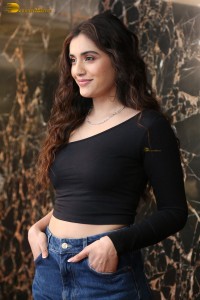 actress divyansha kaushik in a black top and denim jeans