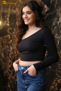 actress divyansha kaushik in a black top and denim jeans