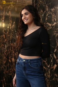 actress divyansha kaushik in a black top and denim jeans