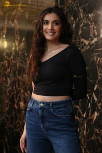 actress divyansha kaushik in a black top and denim jeans