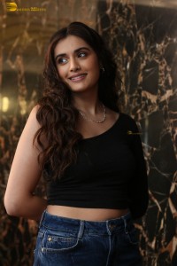 actress divyansha kaushik in a black top and denim jeans