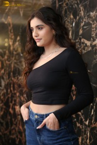 actress divyansha kaushik in a black top and denim jeans