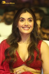 actress divyansha kaushik hot looks in a red lehenga choli at a movie function