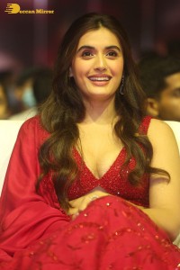 actress divyansha kaushik hot looks in a red lehenga choli at a movie function