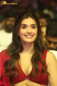 actress divyansha kaushik hot looks in a red lehenga choli at a movie function