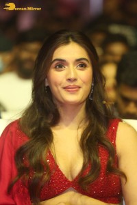 actress divyansha kaushik hot looks in a red lehenga choli at a movie function