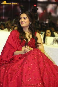 actress divyansha kaushik hot looks in a red lehenga choli at a movie function