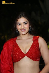 actress divyansha kaushik hot looks in a red lehenga choli at a movie function