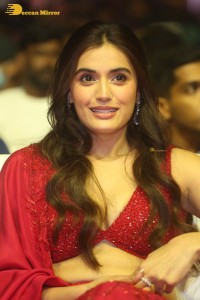 actress divyansha kaushik hot looks in a red lehenga choli at a movie function