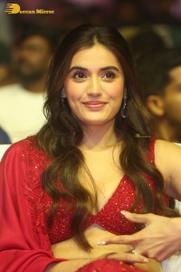 actress divyansha kaushik hot looks in a red lehenga choli at a movie function