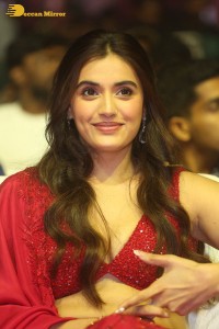 actress divyansha kaushik hot looks in a red lehenga choli at a movie function