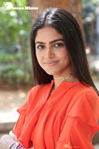 Actress Drishika Chander in a orange dress