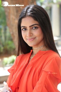 Actress Drishika Chander in a orange dress
