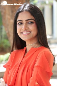 Actress Drishika Chander in a orange dress