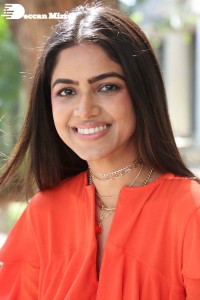 Actress Drishika Chander in a orange dress