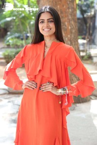 Actress Drishika Chander in a orange dress