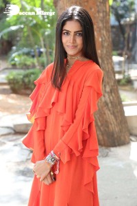 Actress Drishika Chander in a orange dress