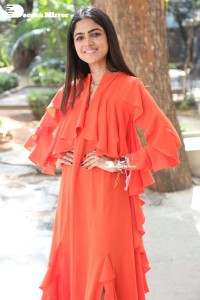 Actress Drishika Chander in a orange dress