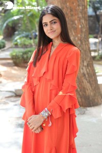 Actress Drishika Chander in a orange dress