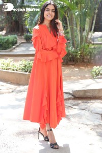 Actress Drishika Chander in a orange dress