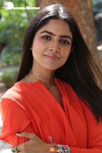 Actress Drishika Chander in a orange dress