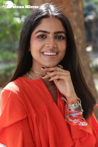 Actress Drishika Chander in a orange dress