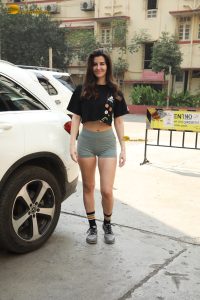 actress Giorgia Andriani cute in a black top and green shorts