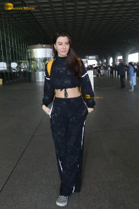 actress Giorgia Andriani in black overalls at mumbai airport