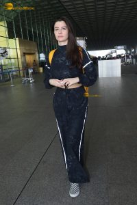 actress Giorgia Andriani in black overalls at mumbai airport