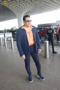 Bollywood Superstar Govinda stops and waits for a fan in wheelchair to take pictures