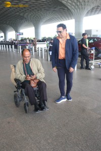 Bollywood Superstar Govinda stops and waits for a fan in wheelchair to take pictures