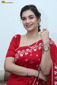 actress Hassini Sudhir glamorous look in a red saree