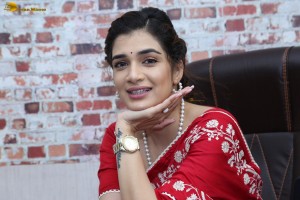 actress Hassini Sudhir glamorous look in a red saree