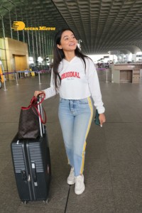 Helly Shah spotted at Mumbai Airport in white t-shirt and blue jeans