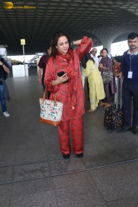 bollywood actress hema malini spotted in a red dress at mumbai airport