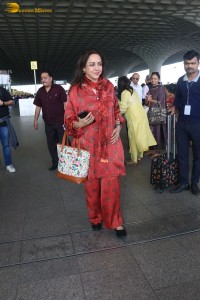 bollywood actress hema malini spotted in a red dress at mumbai airport