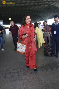 bollywood actress hema malini spotted in a red dress at mumbai airport