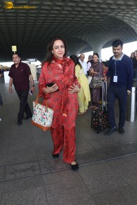 bollywood actress hema malini spotted in a red dress at mumbai airport