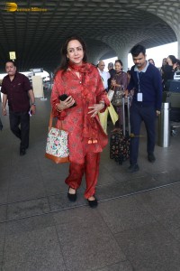 bollywood actress hema malini spotted in a red dress at mumbai airport