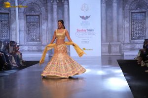 actress hina khan gorgeous in a yellow lehenga choli doing a ramp walk