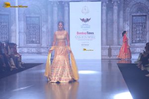 actress hina khan gorgeous in a yellow lehenga choli doing a ramp walk
