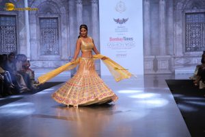 actress hina khan gorgeous in a yellow lehenga choli doing a ramp walk