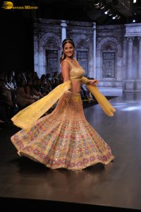 actress hina khan gorgeous in a yellow lehenga choli doing a ramp walk