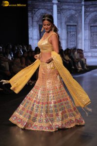 actress hina khan gorgeous in a yellow lehenga choli doing a ramp walk