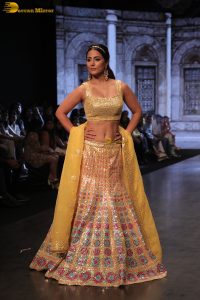 actress hina khan gorgeous in a yellow lehenga choli doing a ramp walk
