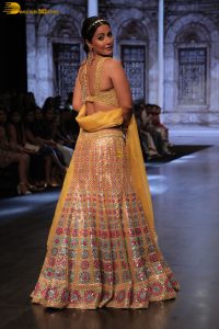 actress hina khan gorgeous in a yellow lehenga choli doing a ramp walk